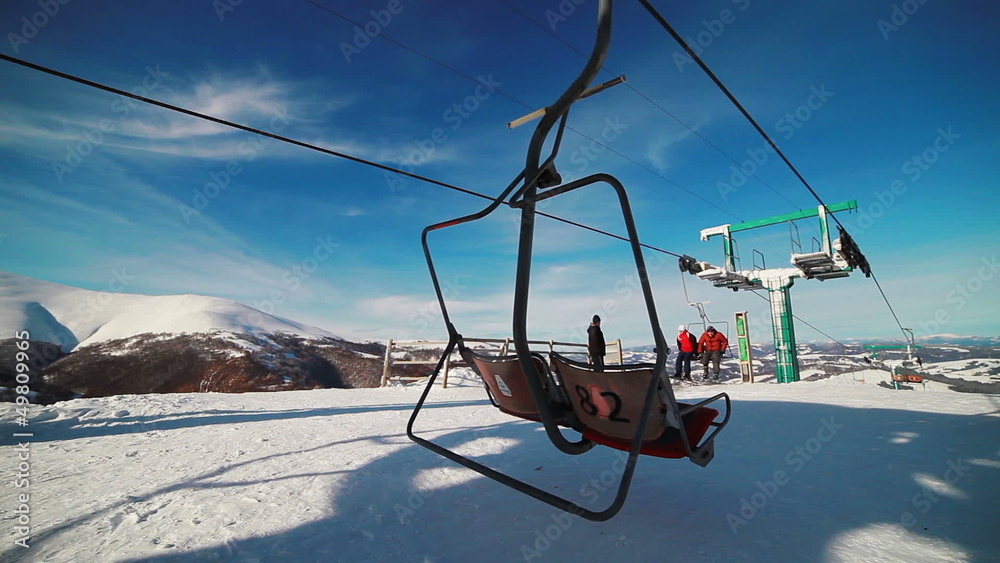 mountain lift carrying skiers to the top mountain lift carrying skiers to the top
