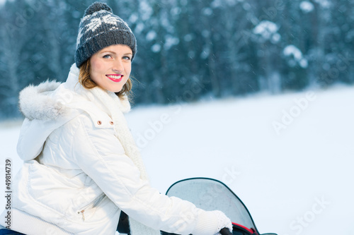 Woman and snowmobile photo