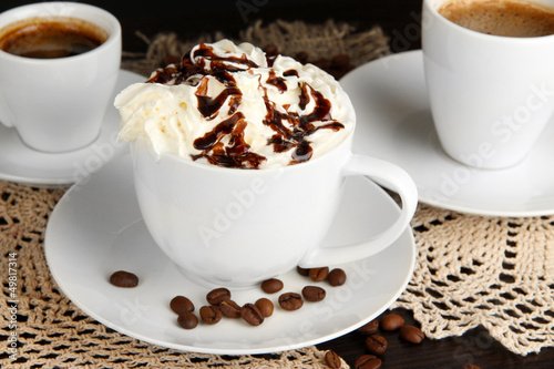 Fototapeta Naklejka Na Ścianę i Meble -  Cup of whipped cream coffee on wooden table close up