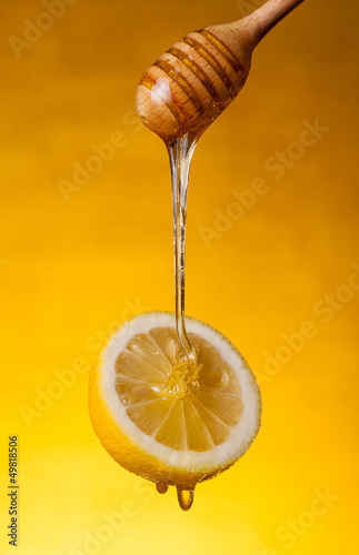 Honey flowing on lemon