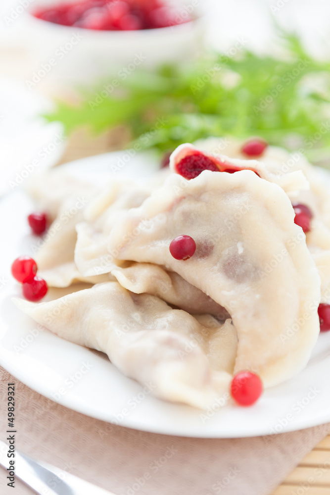 cooked cranberry dumplings on white dish