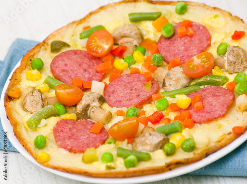pizza with salami, mushrooms and vegetables