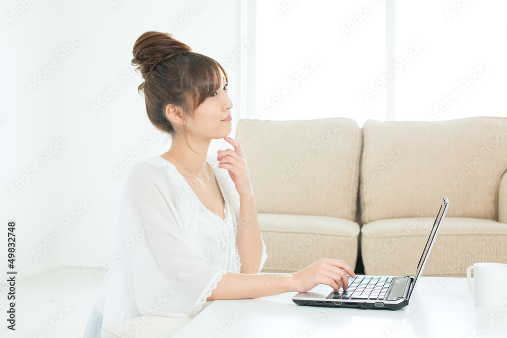 Beautiful asian woman using a laptop computer Beautiful asian woman using a laptop computer