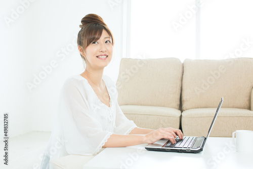 Beautiful asian woman using a laptop computer © one