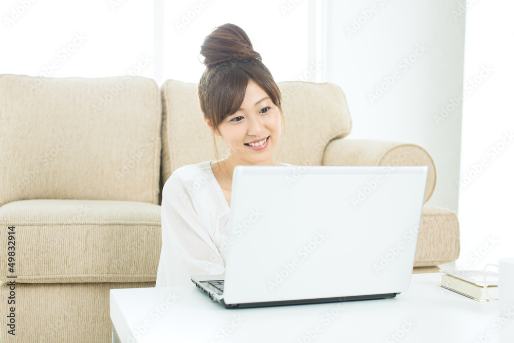 Beautiful asian woman using a laptop computer Beautiful asian woman using a laptop computer