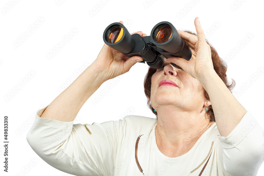 Elderly woman looks through binocular Elderly woman looks through binocular