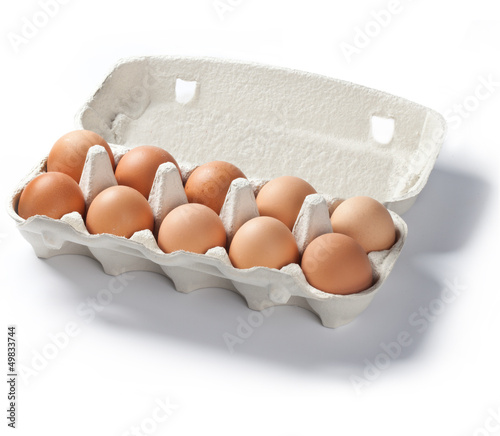 open pack of ten fresh eggs on white