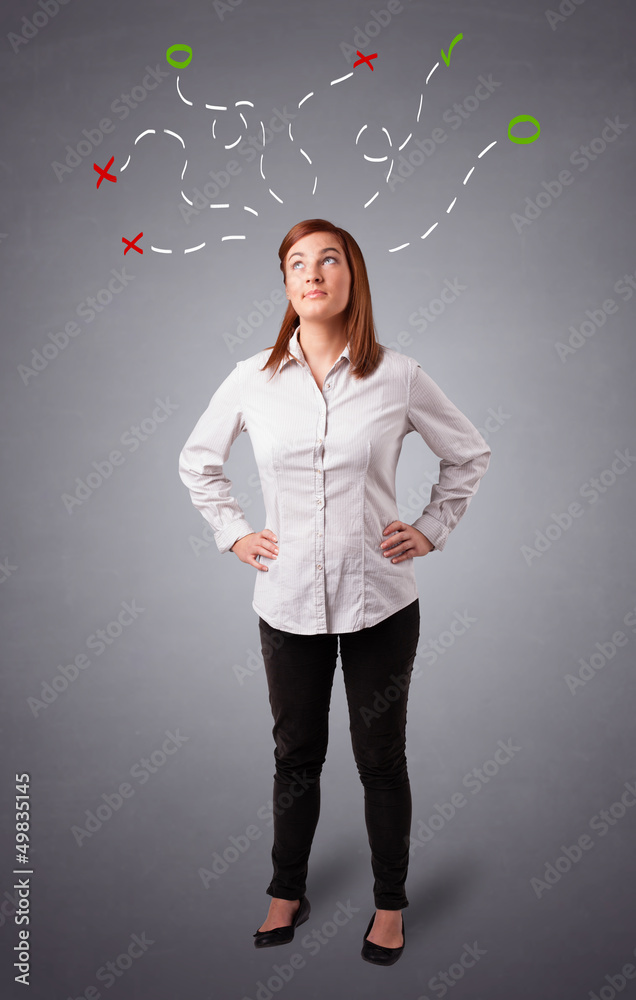Young woman thinking with abstract marks overhead Young woman thinking with abstract marks overhead