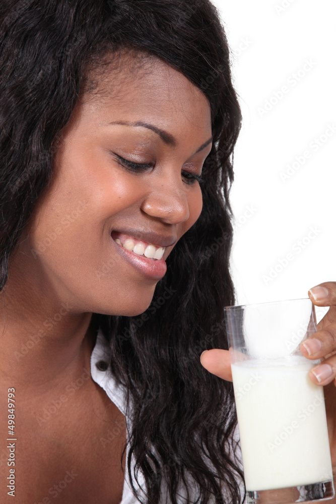 Afro-American woman smiling with glass of milk Afro-American woman smiling with glass of milk