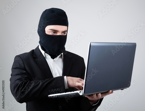 Hacker stealing information from laptop