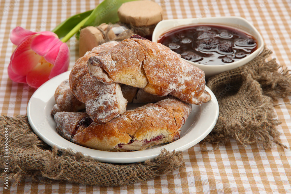 Taste croissants on plate and jam on tablecloth. Taste croissants on plate and jam on tablecloth.