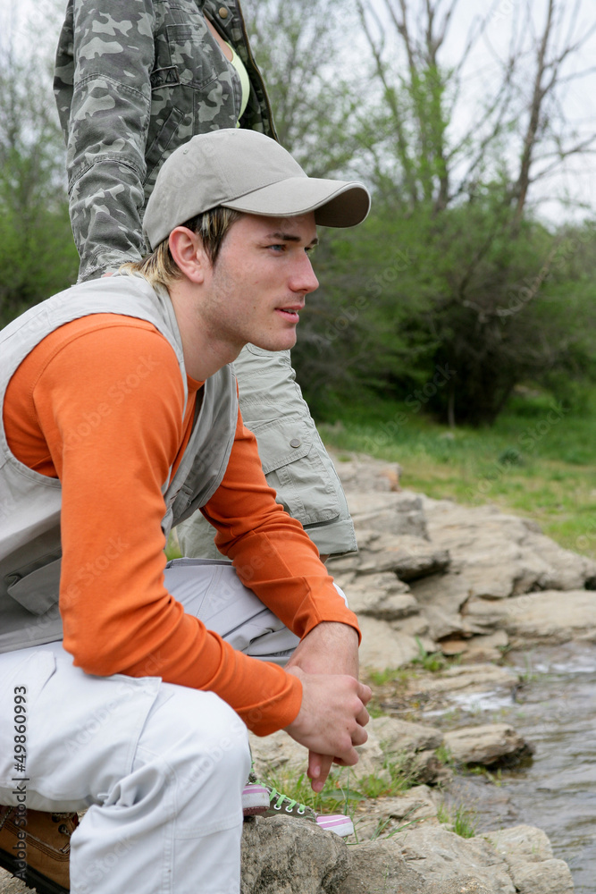 Man sitting at a riverside