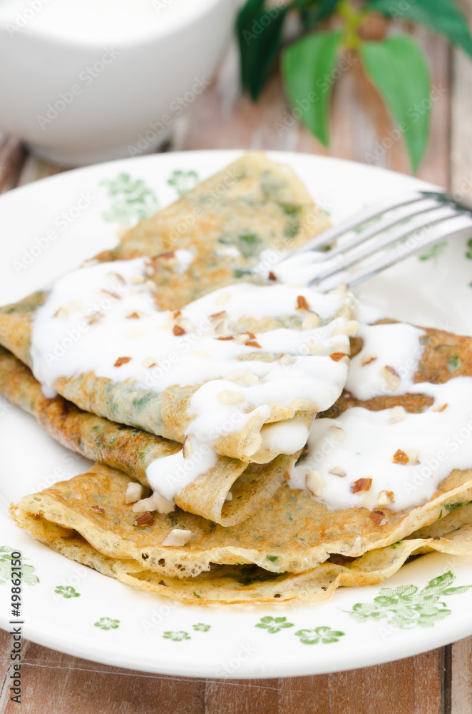 crepes with spinach with yogurt sauce and nuts vertical crepes with spinach with yogurt sauce and nuts vertical