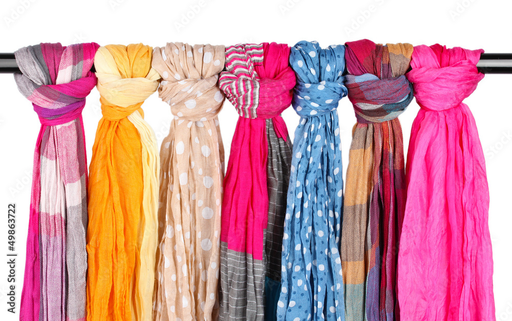 Many bright female scarfs isolated on white