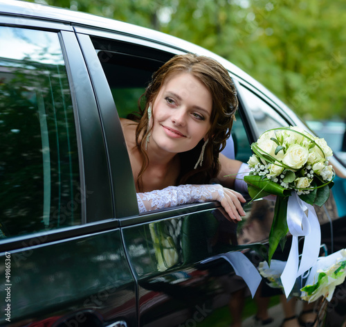 Portrait smiling bride in a car window