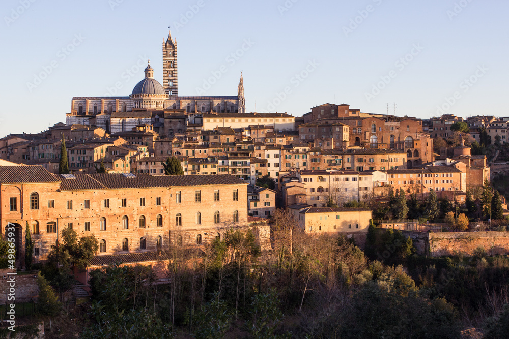 Old town of medieval Siena at sunset.