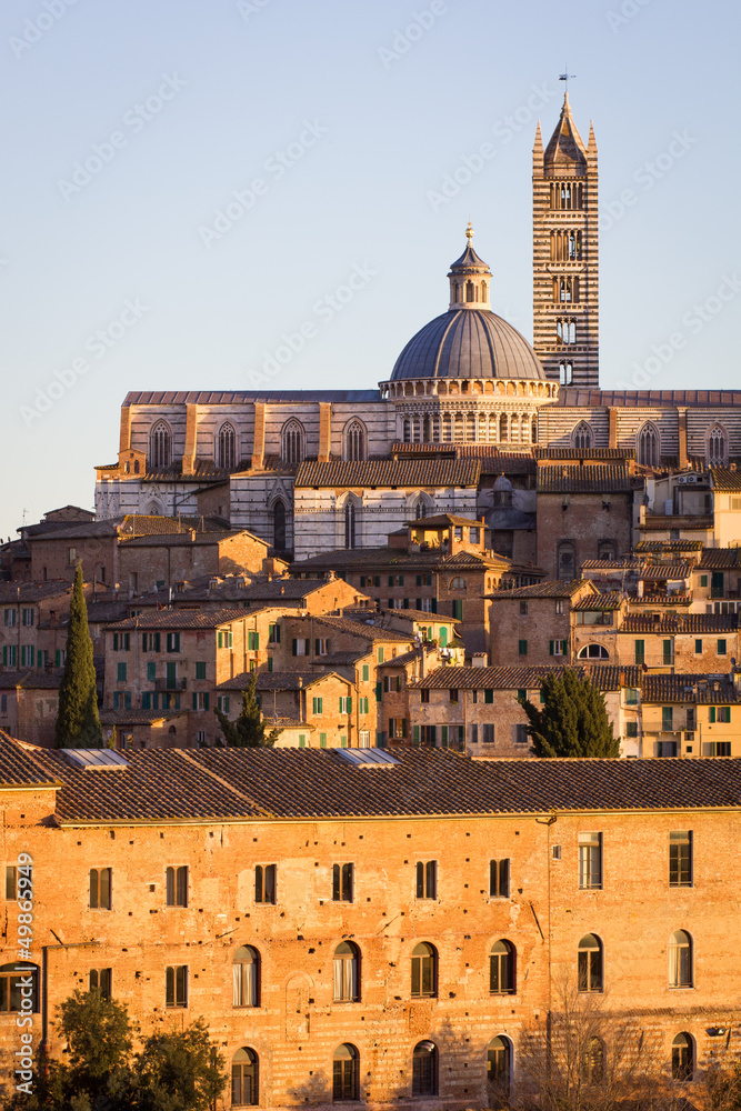 Cathedral in the old town of medieval Siena at sunset.