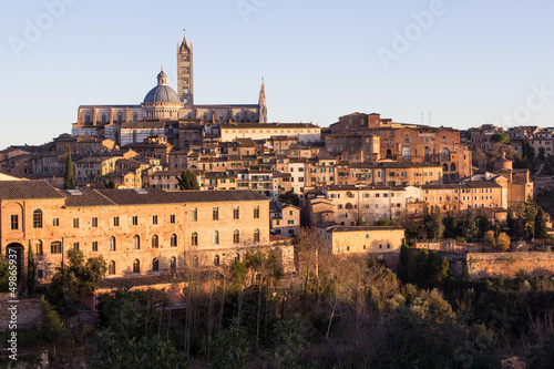 Old town of medieval Siena at sunset.