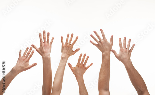 Many hands reaching out in the air