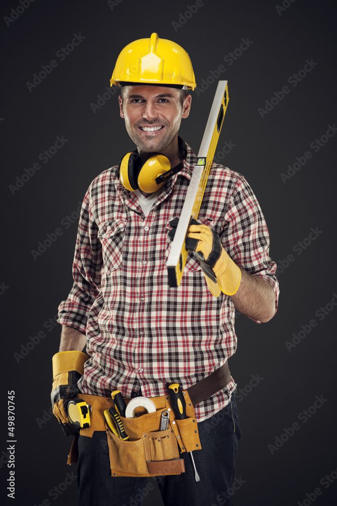 Smiling construction worker holding measuring Smiling construction worker holding measuring