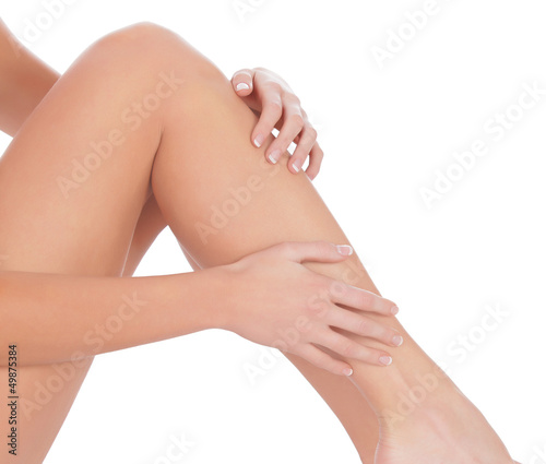 Woman sitting on the floor touch leg by hand