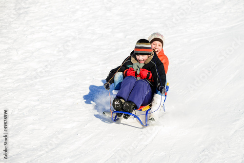 Little boy and girl on sleigh