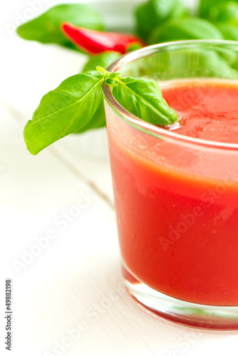 Tomato juice on white wooden table background