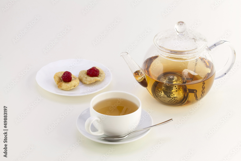 A cup of tea, candied fruits and teapot A cup of tea, candied fruits and teapot