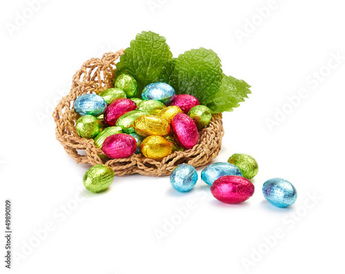 Colorful Easter Eggs in a nest with mint leaves