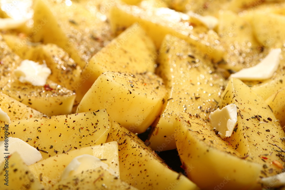 Raw potatoes with spices ready to be roasted Raw potatoes with spices ready to be roasted