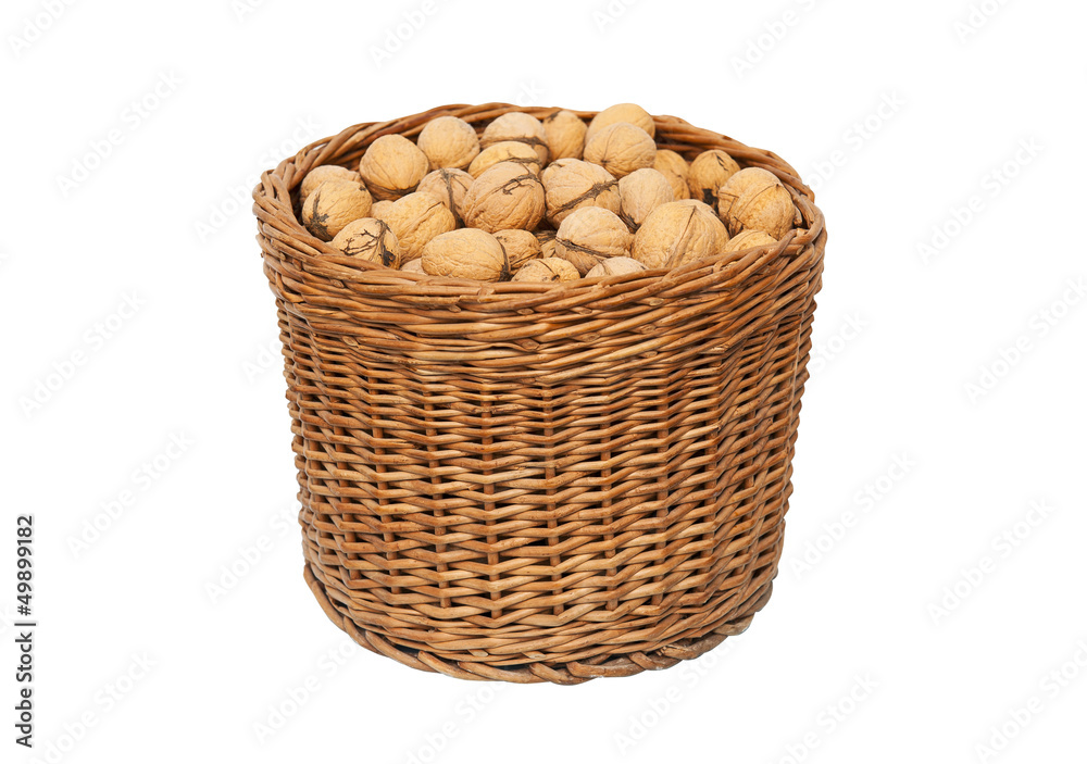 Walnuts in wicker basket isolated on white background Walnuts in wicker basket isolated on white background
