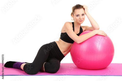 Young woman with gym ball isolated on white