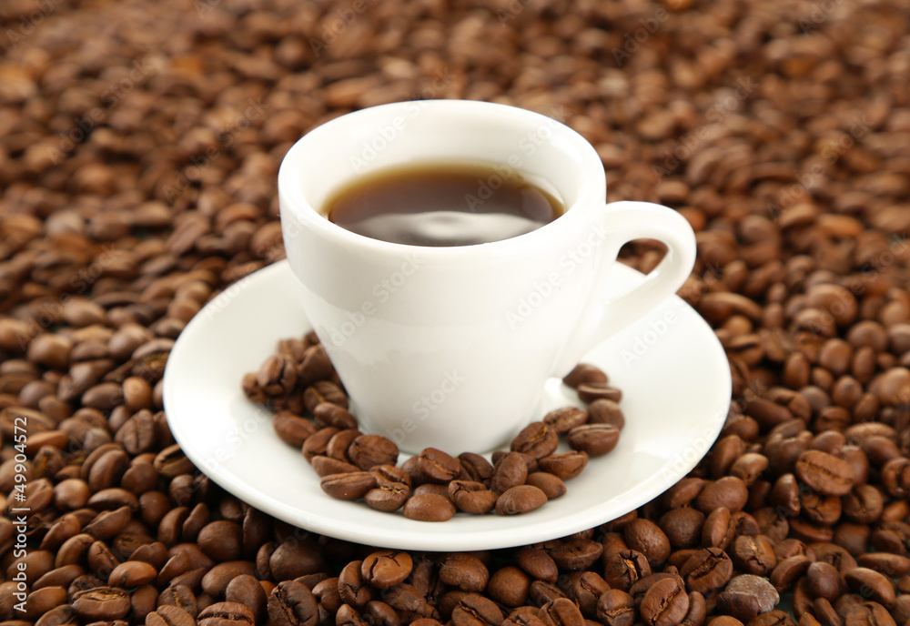 Cup of coffee on coffee beans background Cup of coffee on coffee beans background