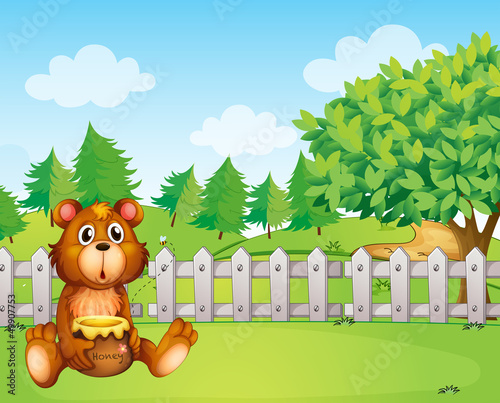 A bear holding a honey at the backyard