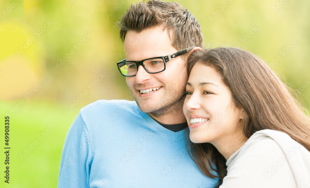 Fototapeta premium Portrait of happy young man and woman in park.