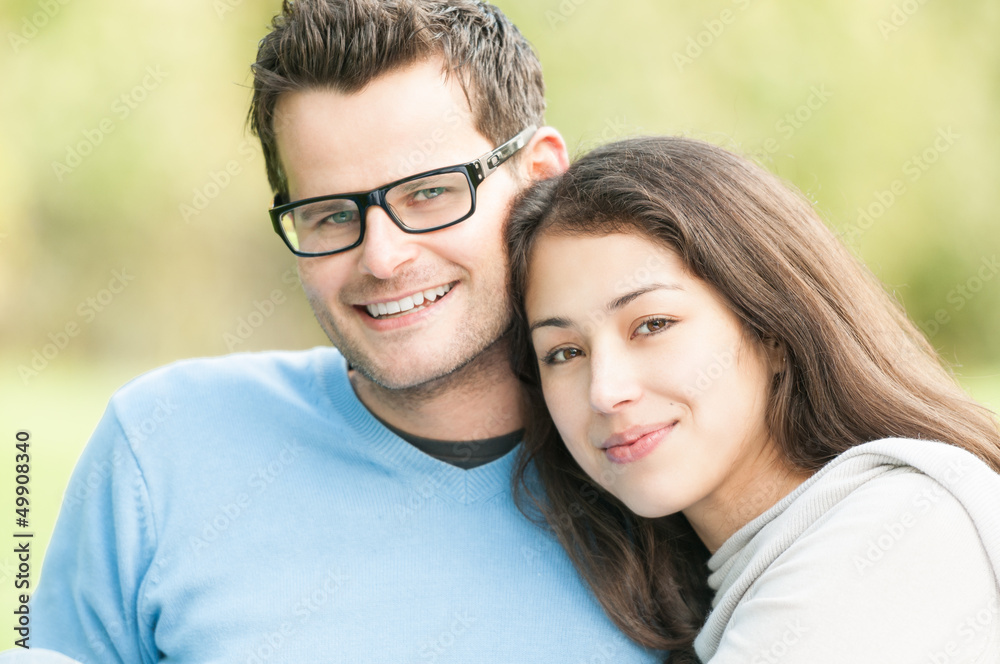 Obraz premium Portrait of happy young man and woman in park.