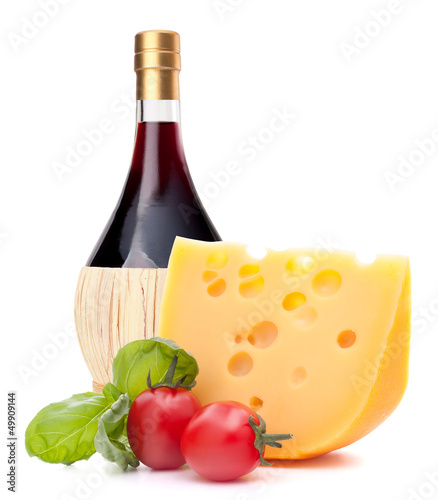 Red wine bottle, cheese and tomato still life