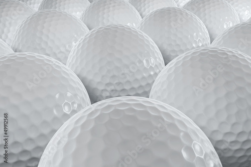 A closeup shot of many golfballs.