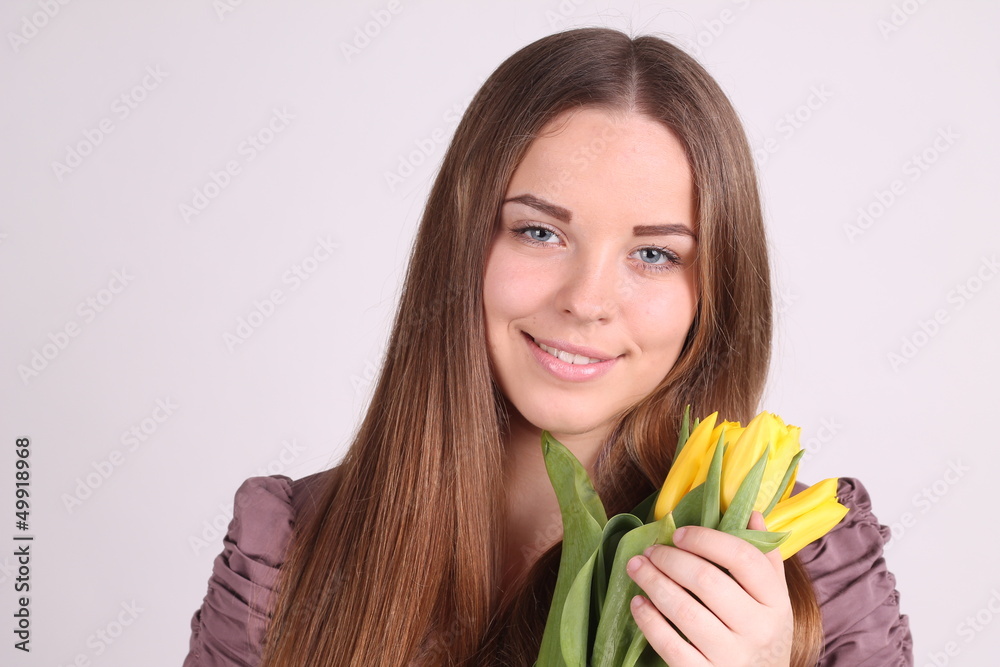 Beautiful woman with long hair with yellow tulips Beautiful woman with long hair with yellow tulips