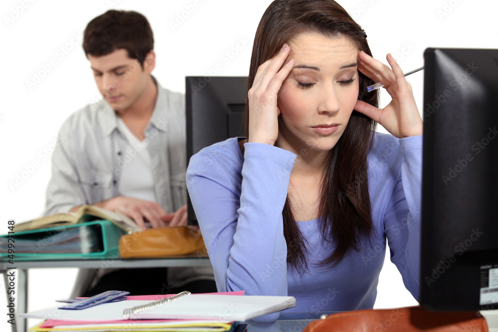 Fototapeta premium Student with a headache at a computer
