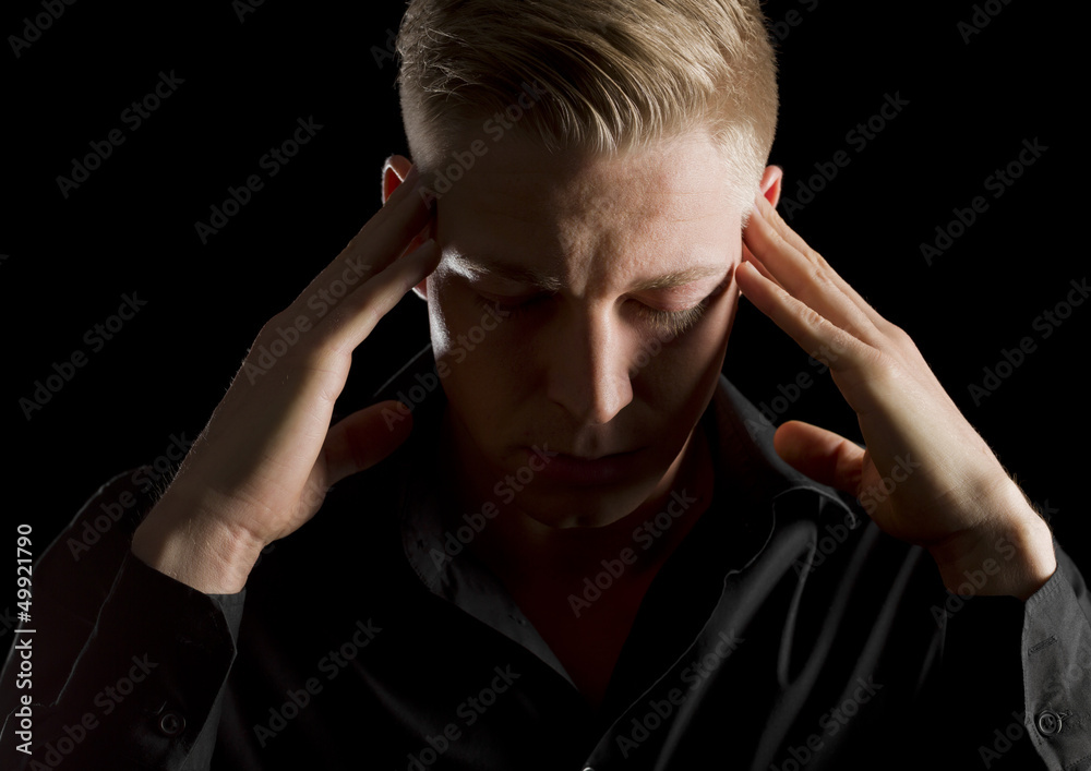 Low key portrait of serious man with eyes closed. Low key portrait of serious man with eyes closed.