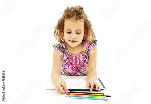 Absorbed little girl drawing with colorful pencils