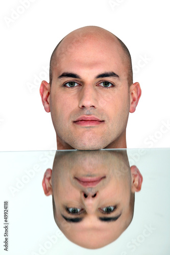 Reflection of bald man