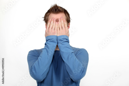 фотографія Man covering his face