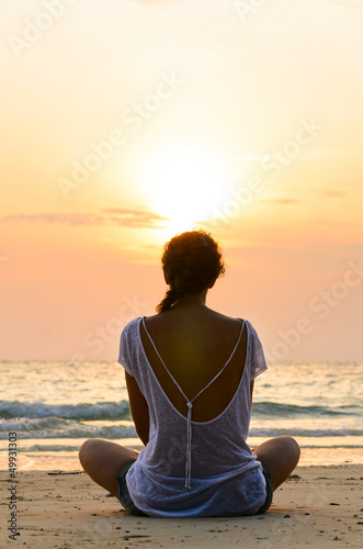 sitting on beach at sunrise © Sergey Peterman