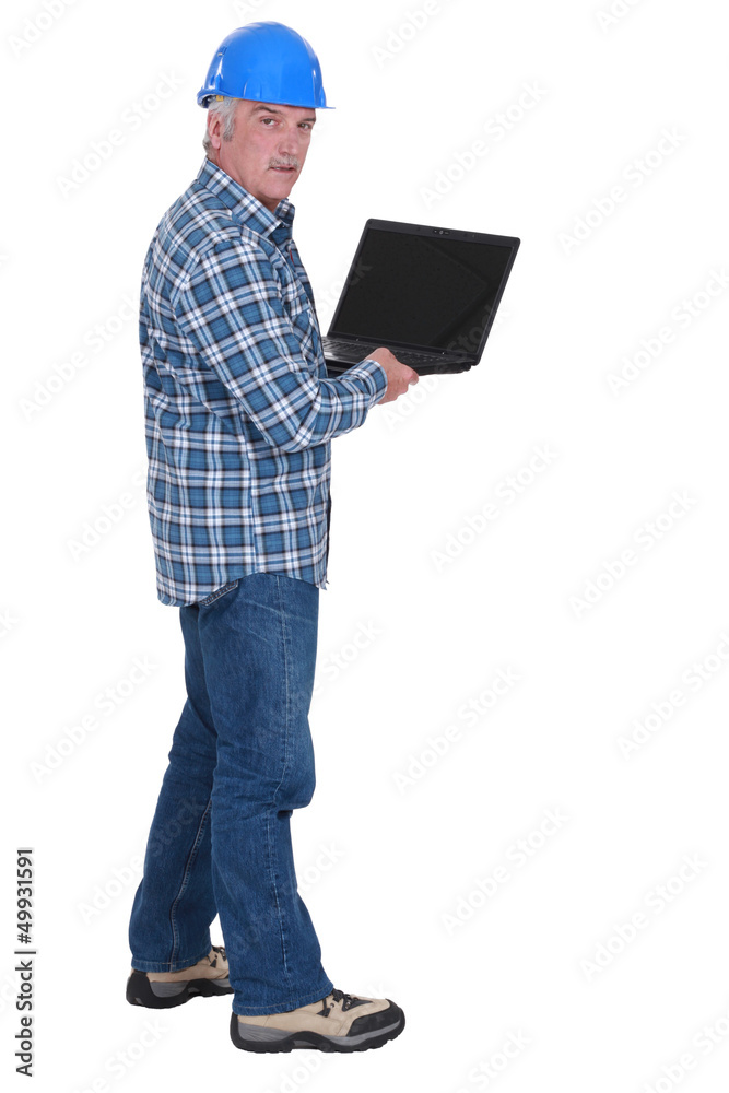 Senior worker holding laptop Senior worker holding laptop