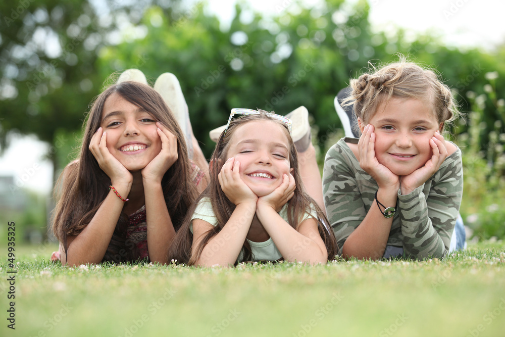 Fototapeta premium Girls lying on grass