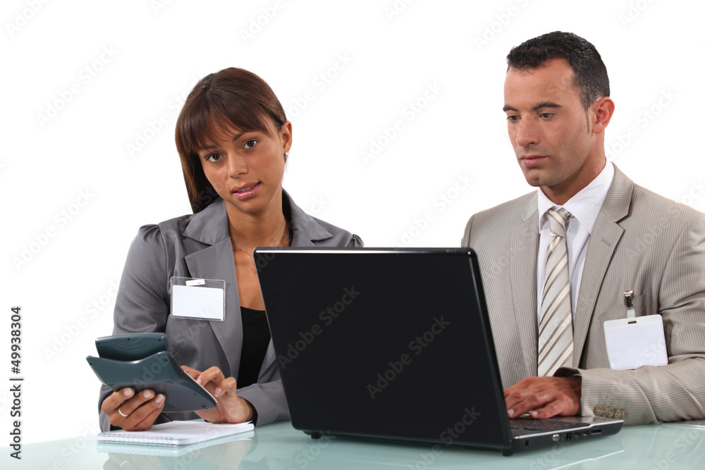 Business couple with a laptop and calculator Business couple with a laptop and calculator