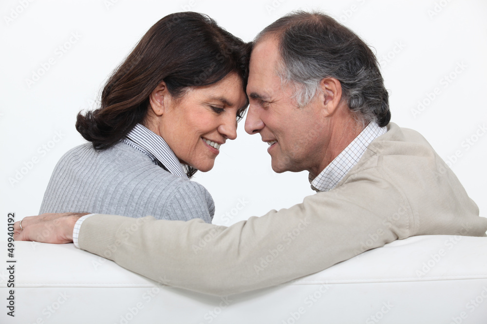 Married couple sat face to face on sofa Married couple sat face to face on sofa