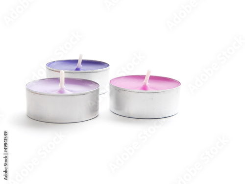Three scented candles not lit on a white background